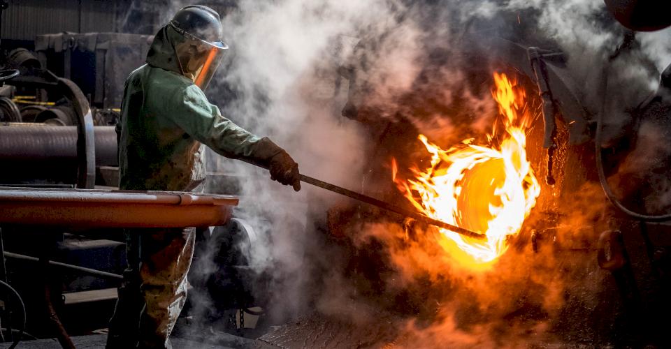 Greasing the spigot side of a casting machine.