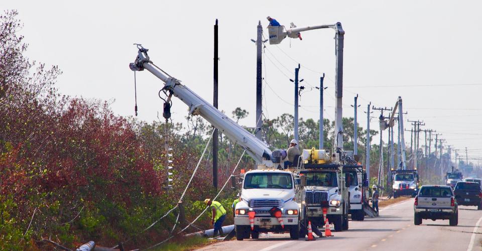 Crews install Ductile iron utility poles for electricity after Hurricane Irma in Florida.