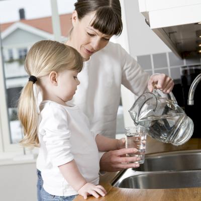 Woman puuring glass of water