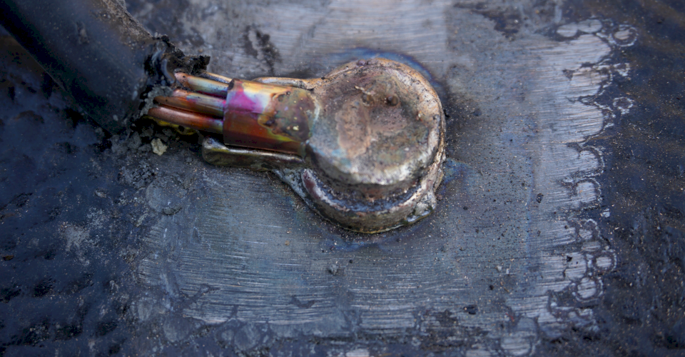 Up close of A finished Cad Weld on Ductile iron pipe.