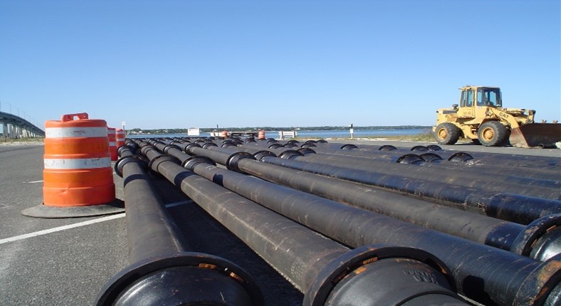 Ball & Socket Pipe is assembled in a staging area prior to installation.