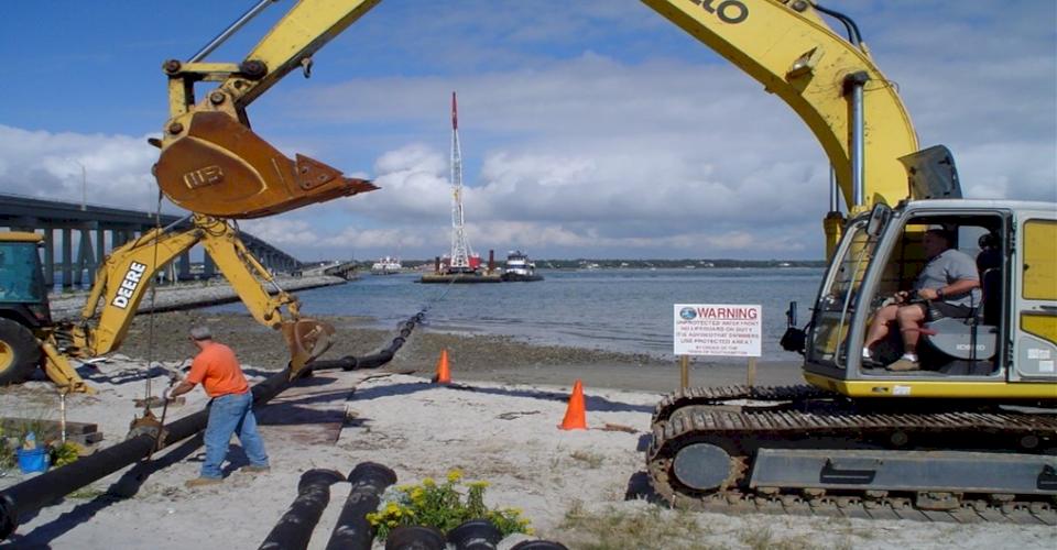 Crane mounted barge/machine push installation.