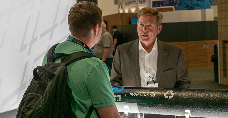 Kevin Bense with McWane chats with a customer during the ACE19 conference.