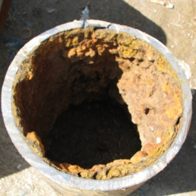 Tuberculation in UNLINED iron pipe.