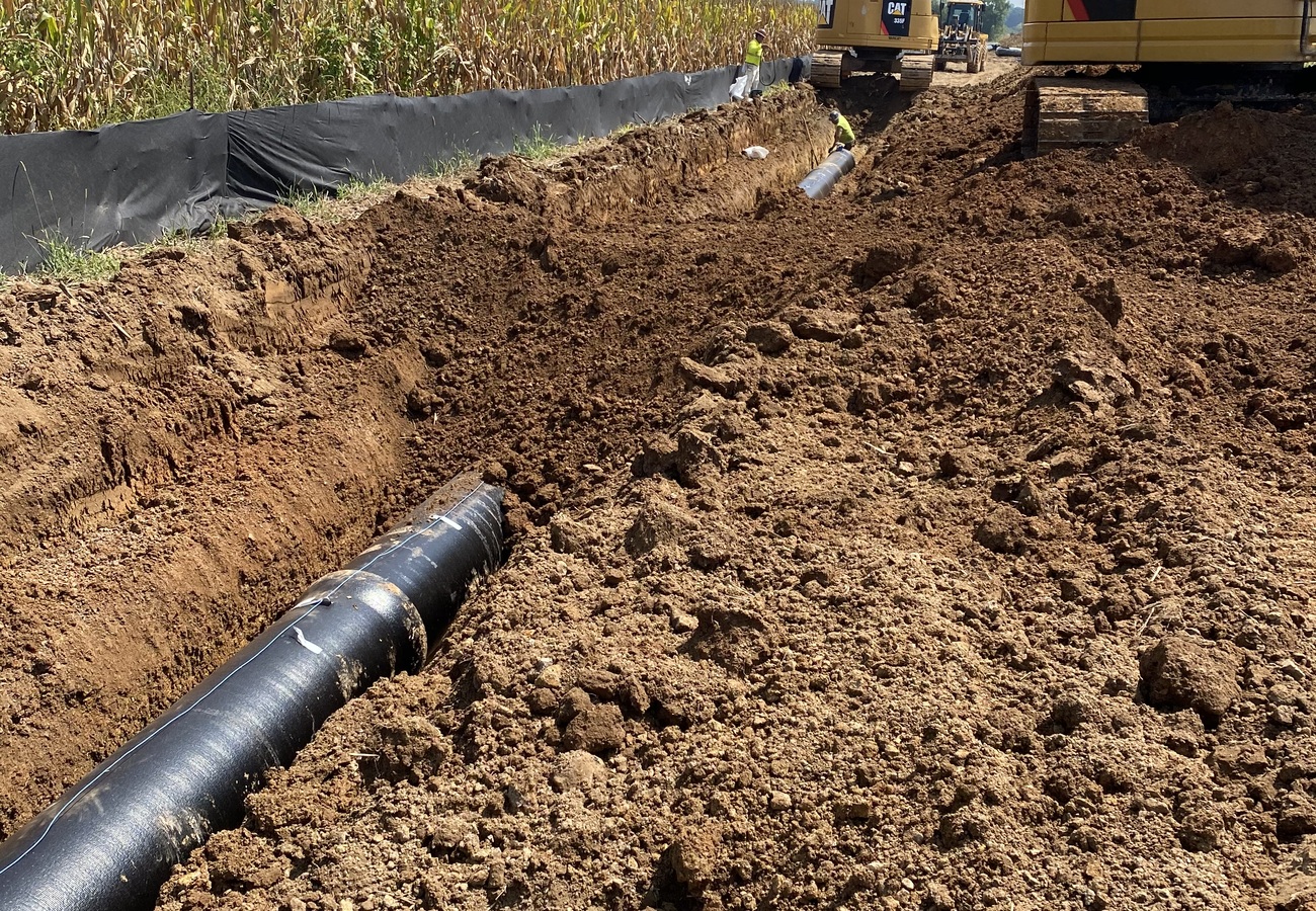 16” pipe in an open trench as Legacy Water Group starts the backfill process.