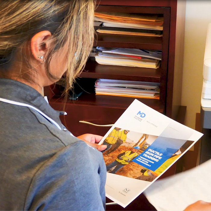 Aichele grabbing training brochure off of printer.
