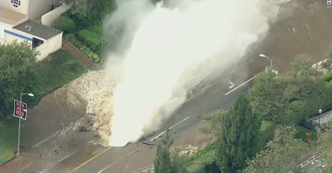 A water main break spews potable water.